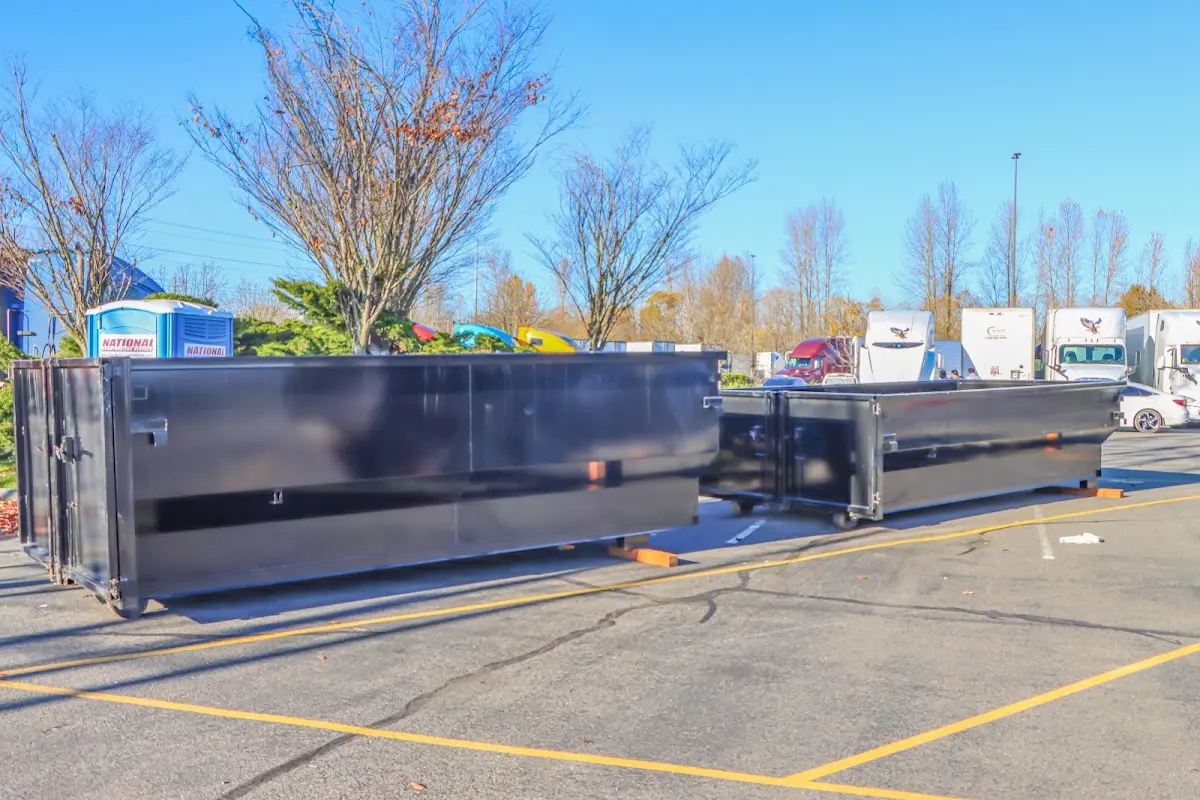 Professional dumpster rental service with roll-off container on residential driveway in Bronxville